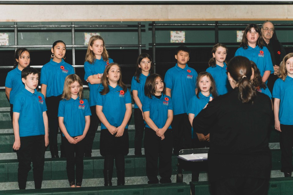 The Fireweed Children's Chorus recites In Flanders Fields. Sarah Pruys/Cabin Radio