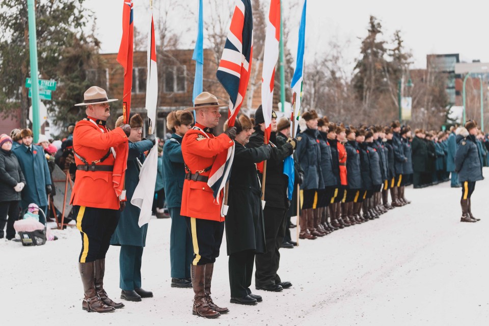 The colour party prepares to lead the parade to the indoor service at St Patrick High School. Sarah Pruys/Cabin Radio