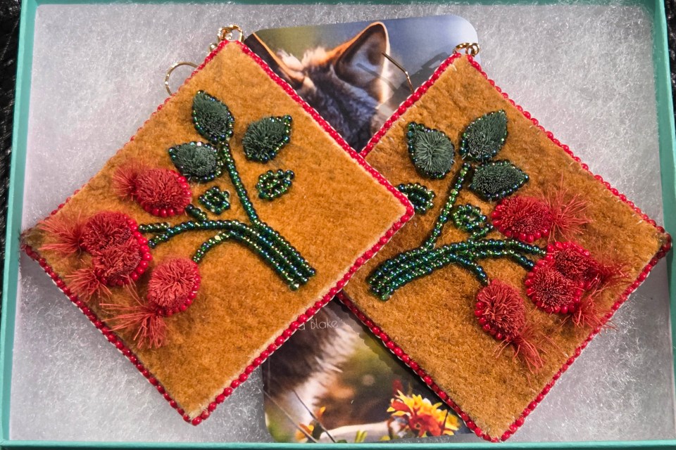 "These 'Rosehip on the Tundra' caribou-tufted earrings are inspired by the quiet beauty of rosehips growing wild across the land. The soft tufts reflect the natural warmth and movement of caribou, while the rosehip theme symbolizes resilience, nourishment, and renewal found in nature. The Charlotte cut beads add a subtle shimmer, like light catching on berries after rain, bringing life and balance to the piece," Blake describes.