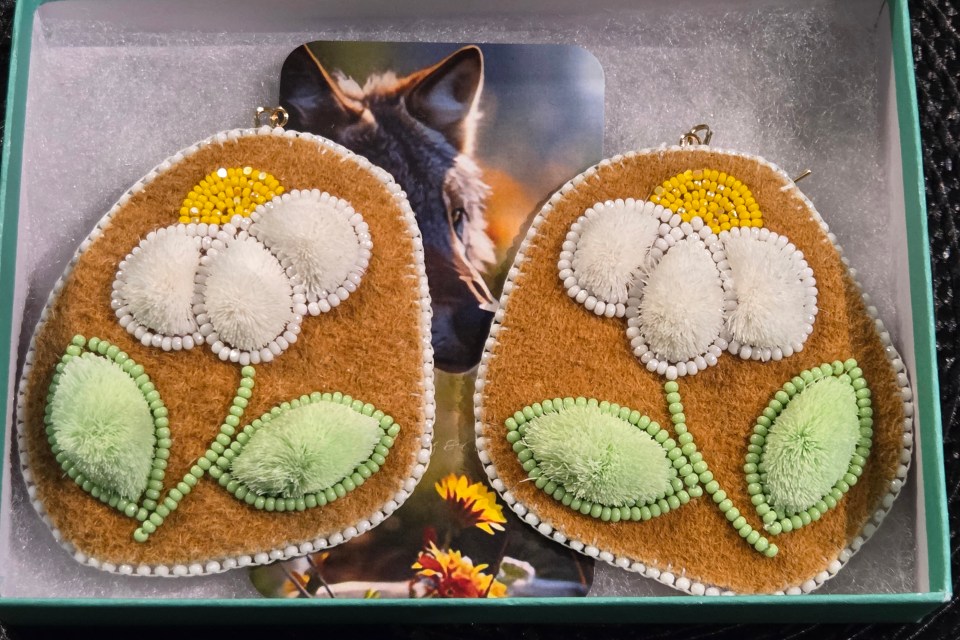 "These caribou-tufted earrings are inspired by the quiet elegance of white petals found in nature—soft blossoms that thrive in open tundra and forest clearings. The white caribou tufts are shaped like petals, reflecting purity, balance, and the gentle movement of flowers stirred by the wind," Blake says. She calls these White Petals of the North.
