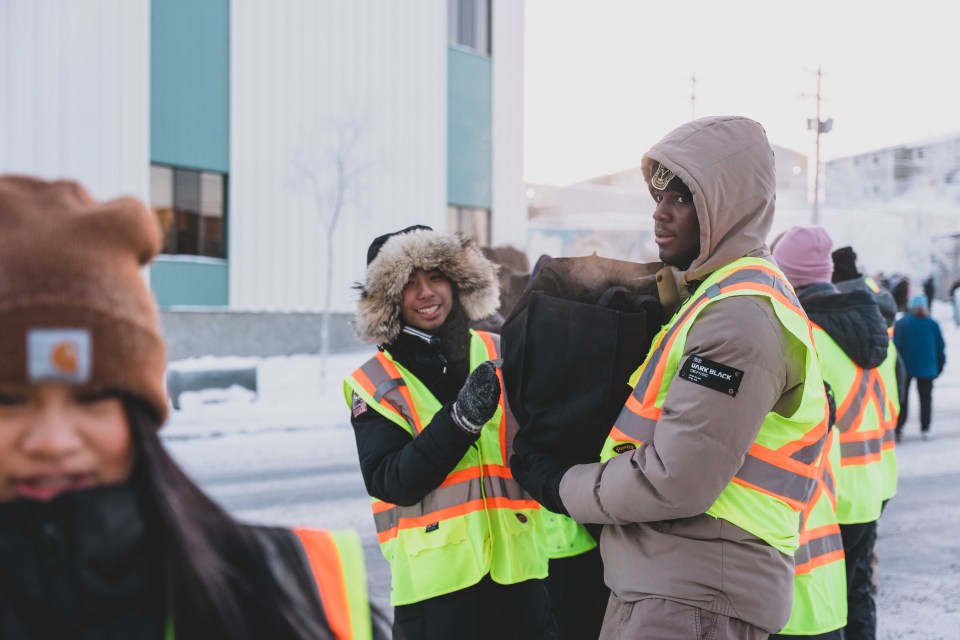 Students pass donations down the line. Sarah Pruys/Cabin Radio