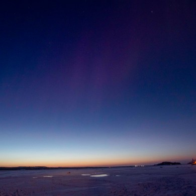 The days are lengthening again. Bill Braden took this photo on the morning of December 21, looking toward Dettah from Yellowknife's Rotary Park. The faintest red aurora is visible.