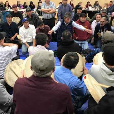 Dene National Chief George Mackenzie, top centre, takes part in hand games during the Dene National Assembly in Fort Good Hope. Cody Punter/Cabin Radio