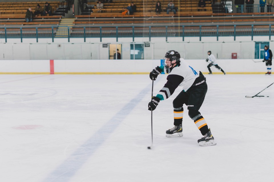 At the U15 male hockey tryouts, a player prepares to shoot the puck. Sarah Pruys/City of Yellowknife
