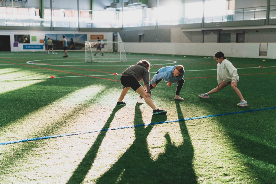 Cross country athletes warm up on the Fieldhouse turf ahead of hitting the track to run laps. Sarah Pruys/City of Yellowknife
