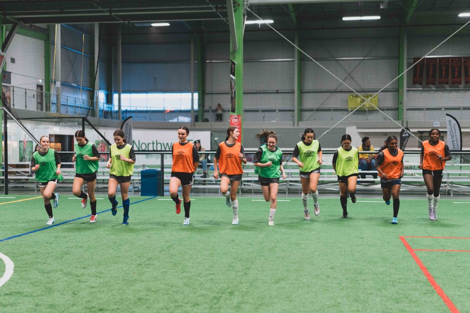 Female futsal hopefuls warm up together ahead of practice. Sarah Pruys/City of Yellowknife