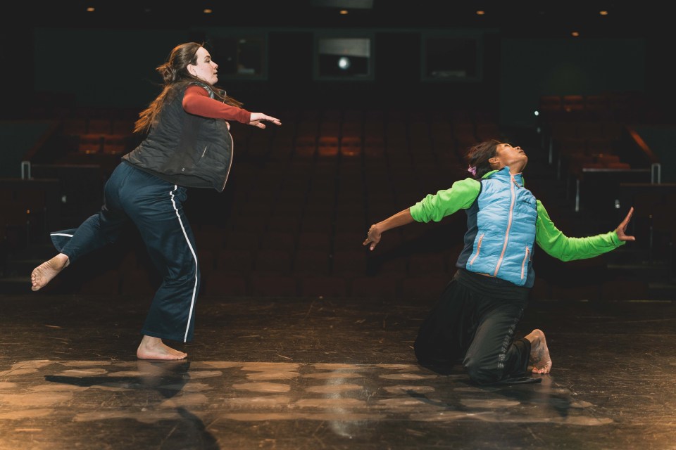Fia Grogono, left, and Chollada Phinitduang practice choreography at Nacc. Sarah Pruys/Cabin Radio
