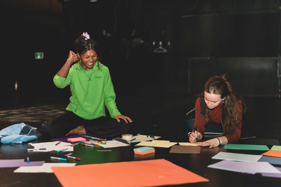 Chollada Phinitduang, left, and Fia Grogono jot down notes about language and physical movement. Sarah Pruys/Cabin Radio