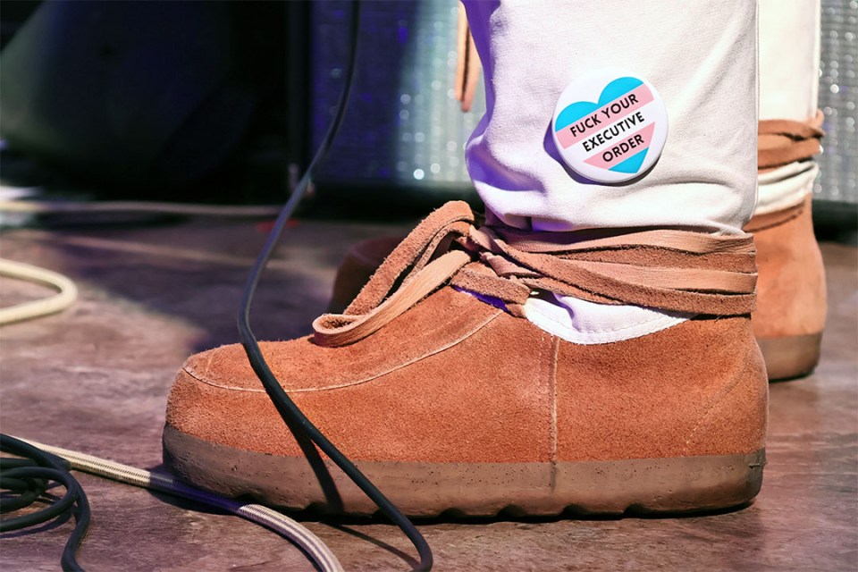 Rainbow button that says "Fuck your executive order" on boots