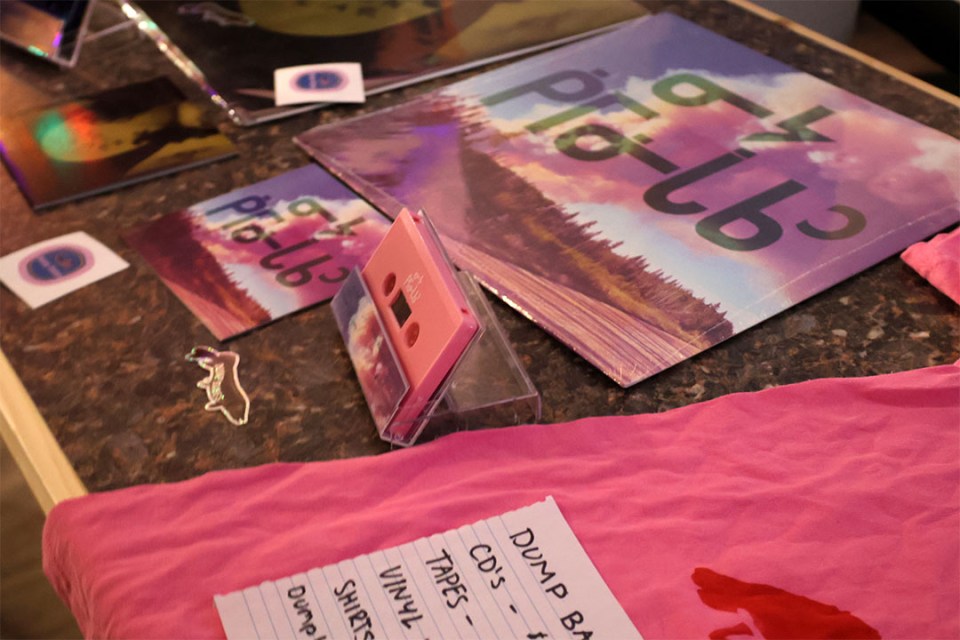 A tape is on display at a merch table.
