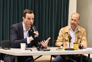 Yellowknife MLAs Kieron Testart, left, and Robert Hawkins address the audience during a February 2026 town hall on community safety and crime prevention. Aastha Sethi/Cabin Radio