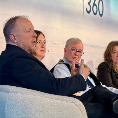 Tłı̨chǫ Investment Corporation boss Paul Gruner, left, at an Arctic 360 panel where former Nunavut senator Dennis Patterson, centre, and Hillary Thatcher of the Canada Infrastructure Bank (right) look on. Ollie Williams/Cabin Radio