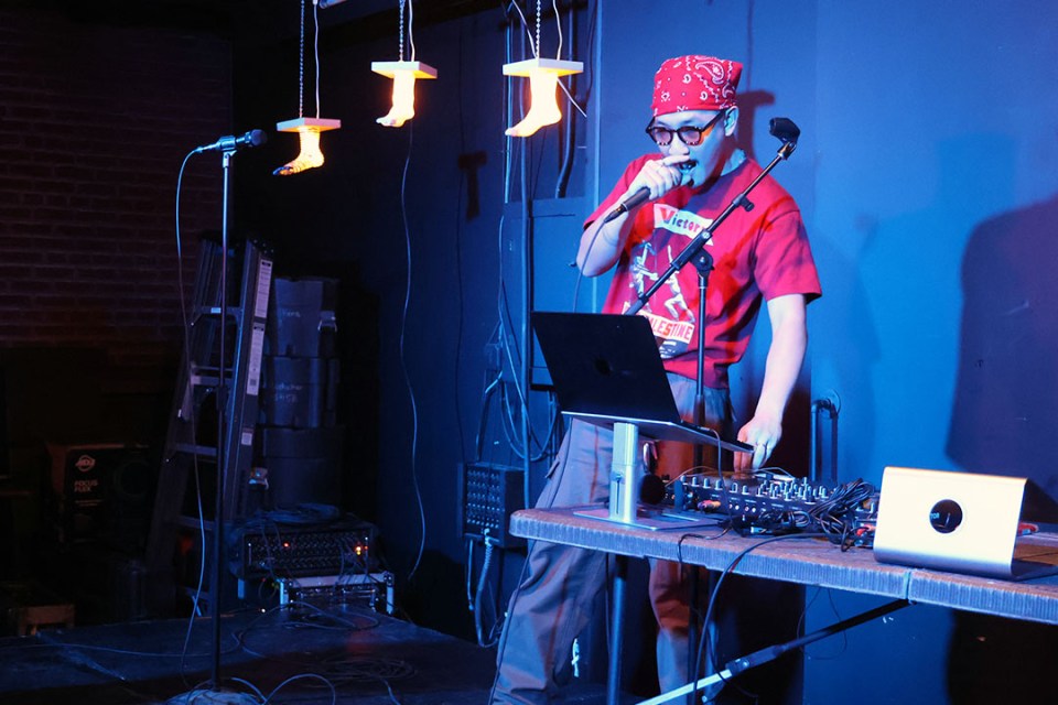 man in front of laptop and microphone