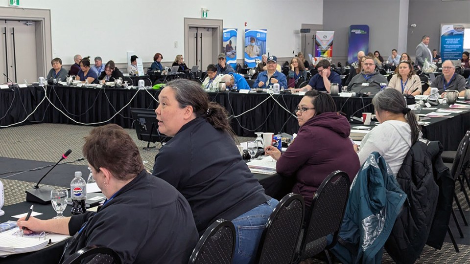 Woman speaking to an audience while seated