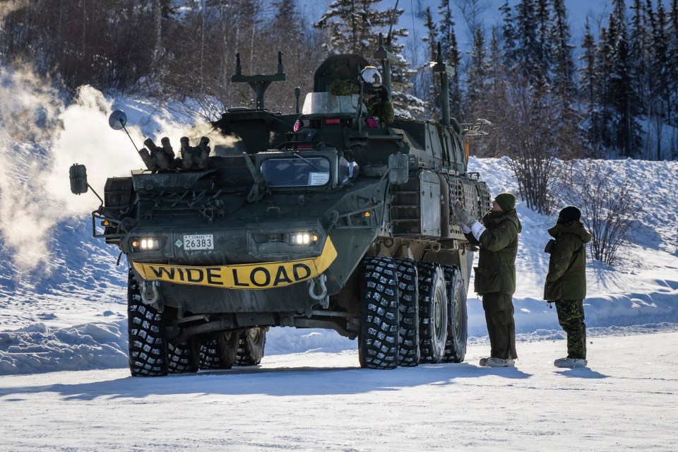 An armoured vehicle and Canadian troops prepare to take part in a training exercise near Yellowknife in February 2026. Ollie Williams/Cabin Radio