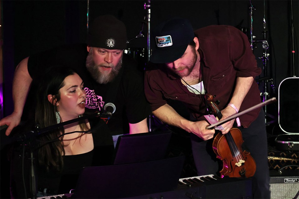 3 people leaned together to sing