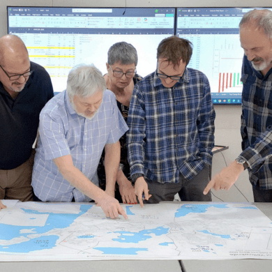 From left: Daryl Dolynny, Kevin O'Reilly, Georgina Rolt, Sam Dyck and chair Robert Gorin look at the NWT's electoral boundaries in a photo from their final report.