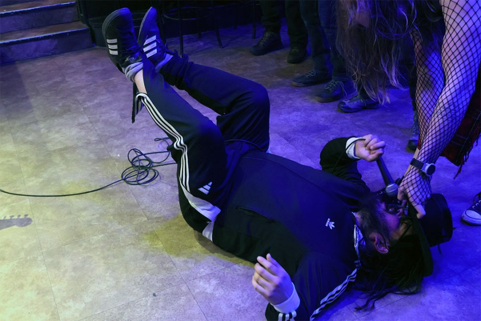 Lead singer of Upper Mall Rats on the ground in front of th crowd