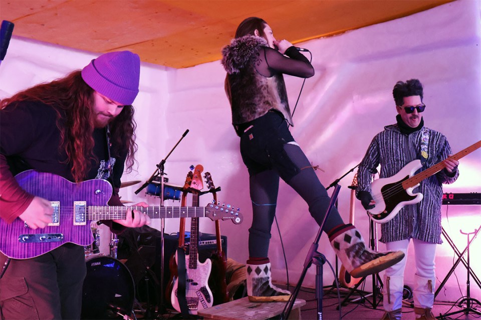 Members of a band perform on stage