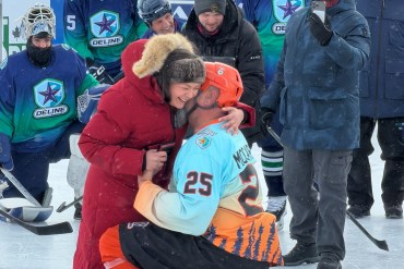 Sandy McCarthy proposes to Mandy Bayha during an NHL alumni game on Great Bear Lake on March 21, 2026. Scott Letkeman/Cabin Radio