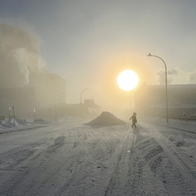 Crossing the street on a cold Yellowknife day in February 2026. Ollie Williams/Cabin Radio