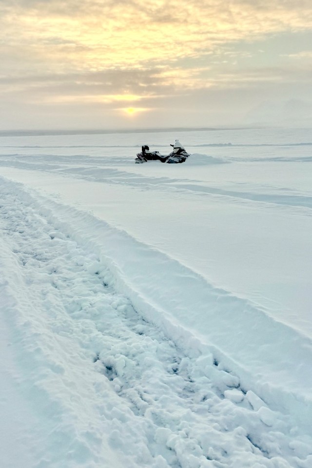One of the family's Ski-Doos, abandoned where it sank into the snow on Cli Lake. Photo: Submitted