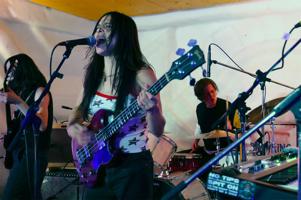 Members of a band perform on stage