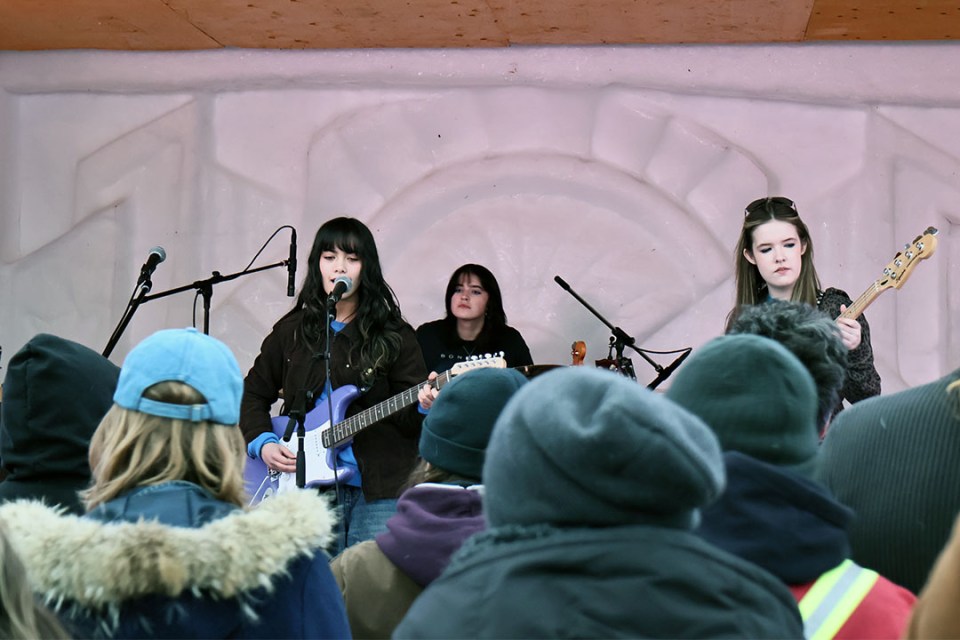 Trio of teen girls perform in front of a crowd