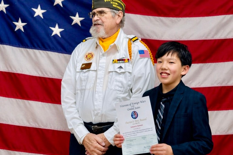 Sebastian Bernabe, right, holds a certificate after placing second in the Patriot's Pen program. Photo: Submitted