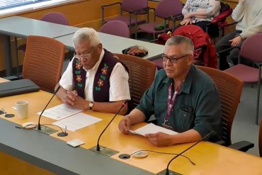 Lawrence Norbert, left, and George Nerysoo, right, speak to MLAs about a proposed anti-SLAPP law.