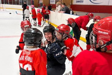 A submitted photo of Shakita Jensen with young hockey players in Iceland.