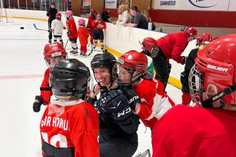 A submitted photo of Shakita Jensen with young hockey players in Iceland.