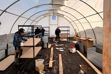 Workers making improvements to Tsiigehtchic's greenhouse. Photo: Colin Xander