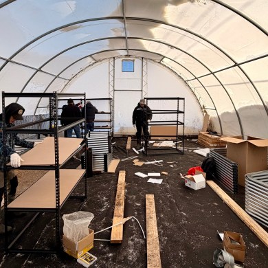 Workers making improvements to Tsiigehtchic's greenhouse. Photo: Colin Xander