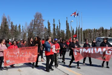 People marched from the legislature building to the Tree of Peace in Yellowknife for Red Dress Day in 2024. Emily Blake/Cabin Radio