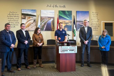 Hay River senior administrator Glenn Smith, flanked by NWT MP Rebecca Alty and Premier RJ Simpson, at a news conference on April 7, 2026. Aastha Sethi/Cabin Radio
