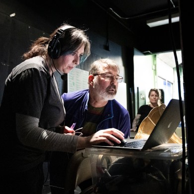 Miriam Bosiljevac, left, and Sean Daly examine a digital copy of a script during a Crazy For You rehearsal. Ollie Williams/Cabin Radio