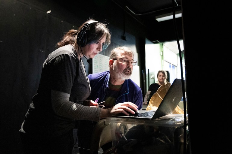 Miriam Bosiljevac, left, and Sean Daly examine a digital copy of a script during a Crazy For You rehearsal. Ollie Williams/Cabin Radio