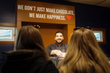 Hamza El Ghazlani serves customers on North Chocolate store opening day. Aastha Sethi/Cabin Radio
