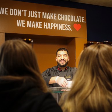 Hamza El Ghazlani serves customers on North Chocolate store opening day. Aastha Sethi/Cabin Radio