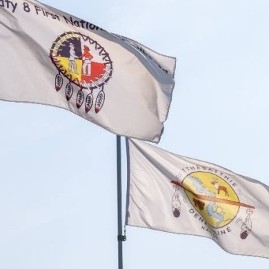 Flags flying at a Tthebatthie Denesųłiné Nation Treaty Day celebration in 2025.Matonabee Paulette/Tthebatthie Denesųłiné Nation