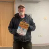 Anthony Foliot with one of his Old Town Versifier signs. Alice Twa/Cabin Radio
