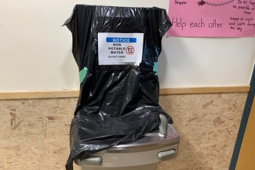 A drinking fountain covered with a trash bag at a Yellowknife high school. Alice Twa/Cabin Radio