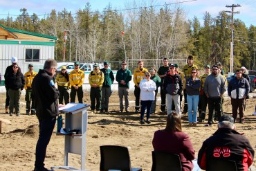 Staff look on as environment minister Jay Macdonald speaks at the territorial fire centre's groundbreaking ceremony in Fort Smith on May 1, 2026. Photo: GNWT