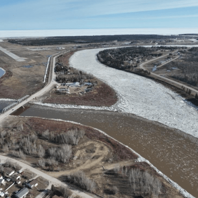 A drone image from May 9, 2026 shows clear water in the Hay River's West Channel and rubble ice in the East Channel. Travis Wright/Town of Hay River