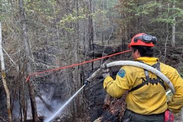 An NWT Fire crew member works on a hotspot on the Klewi Complex. Photo: NWT Fire