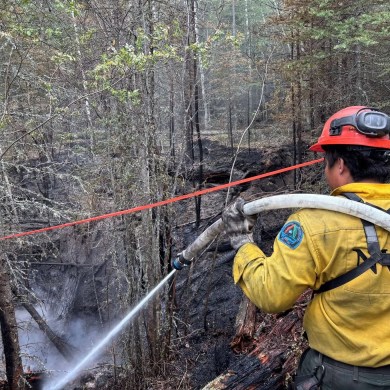 An NWT Fire crew member works on a hotspot on the Klewi Complex. Photo: NWT Fire