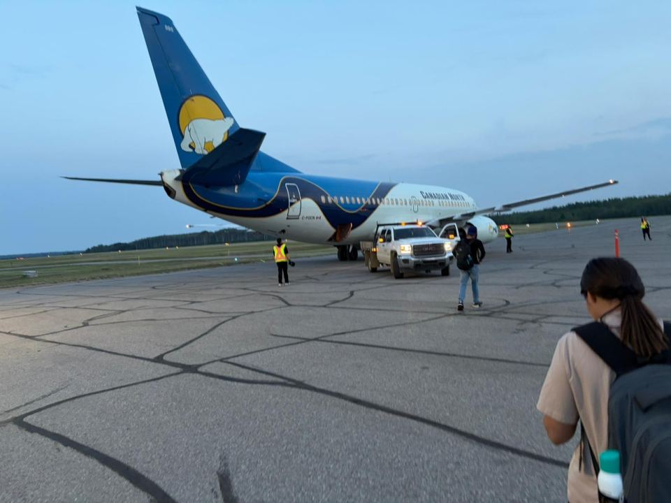 Evacuees head to a Canadian North flight late on June 28, 2026. Photo: Submitted