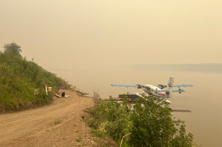 A floatplane in the smoke surrounding Fort Simpson on June 29, 2026. Photo: Diedra Villeneuve