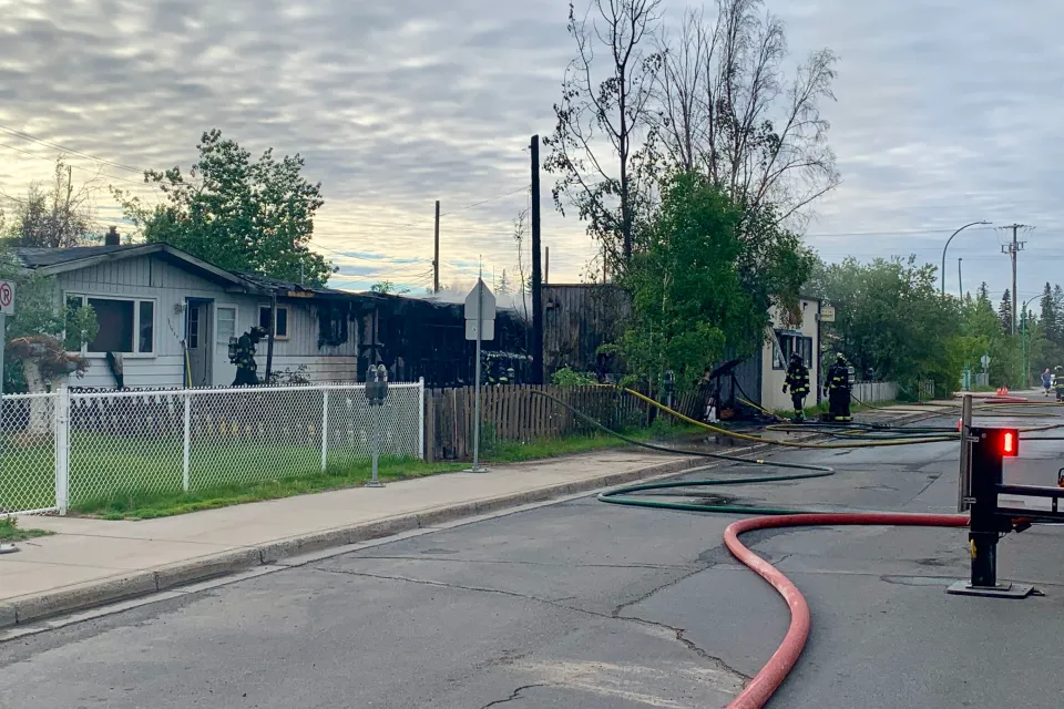 Firefighters address the aftermath of a fire on Yellowknife's 49 Street early on June 18, 2026. Alice Twa/Cabin Radio